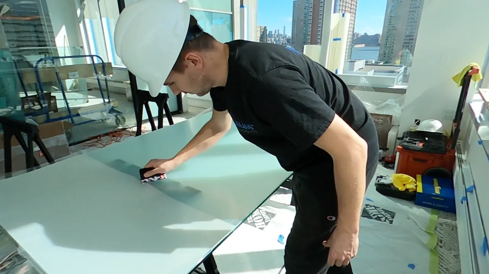 Smart Glass Technologies installer applying film to a glass panel